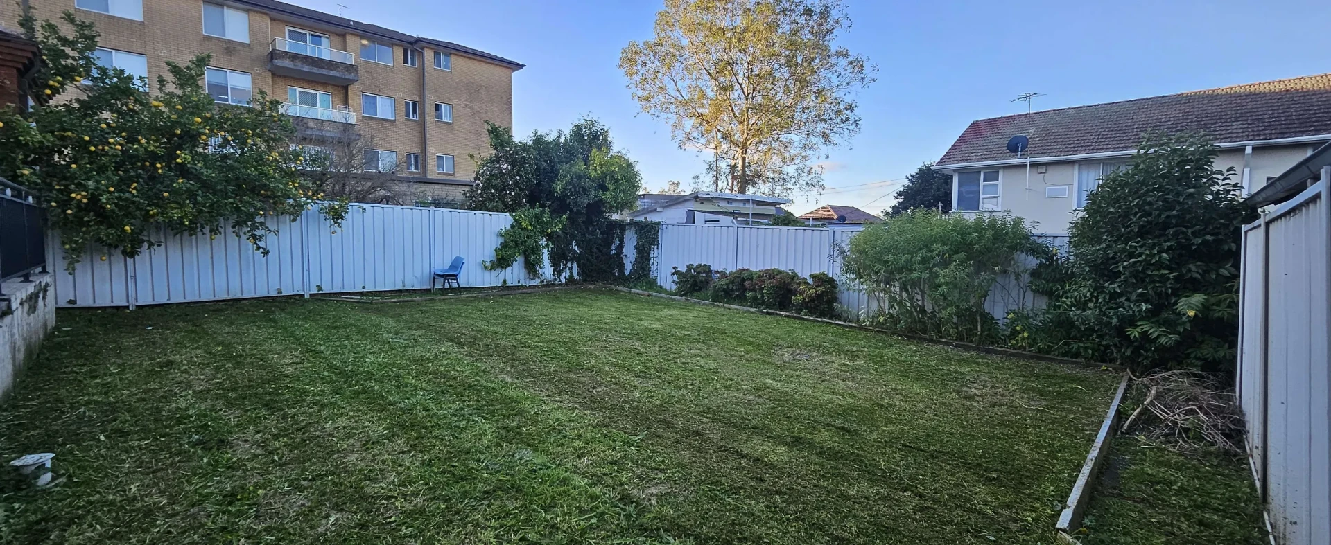 Tidy mowed lawn and cleared garden beds at a vacated rental property